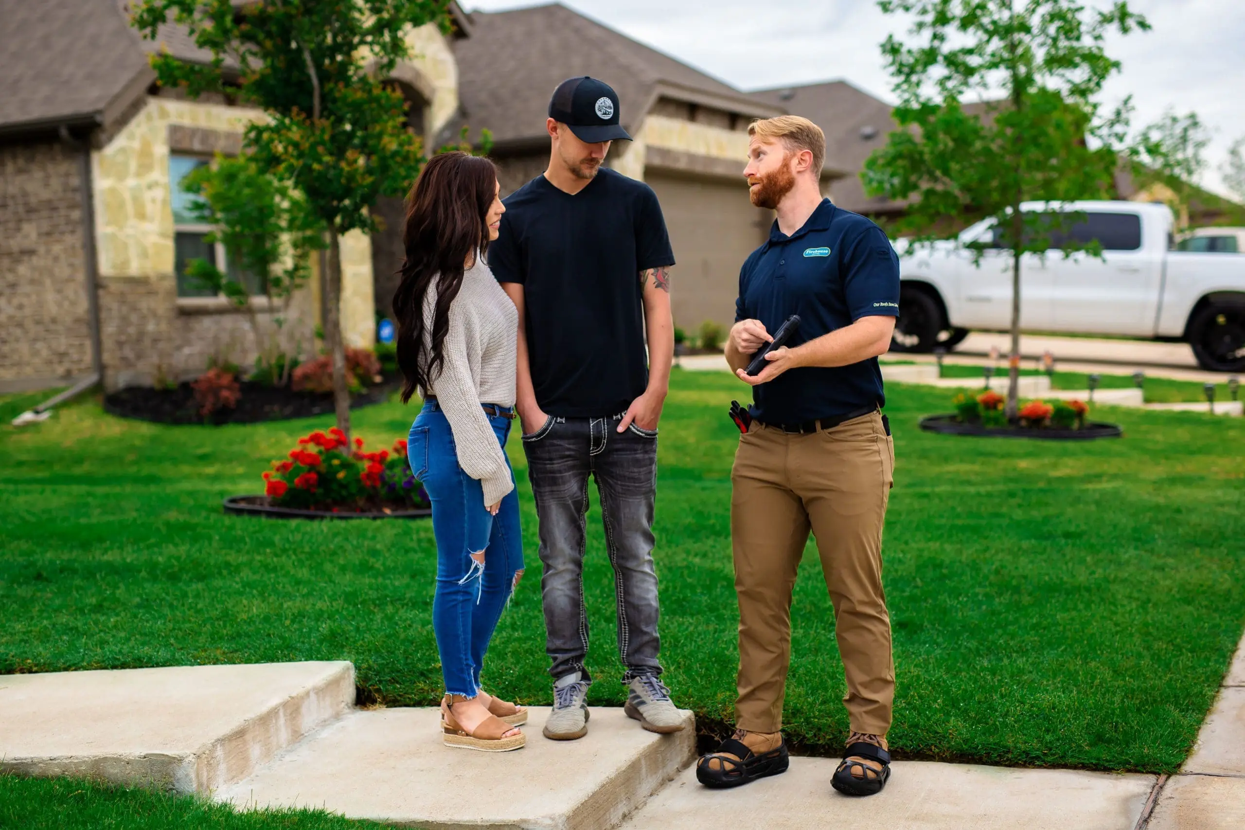 Firehouse Roofing technician speaking with homeowners