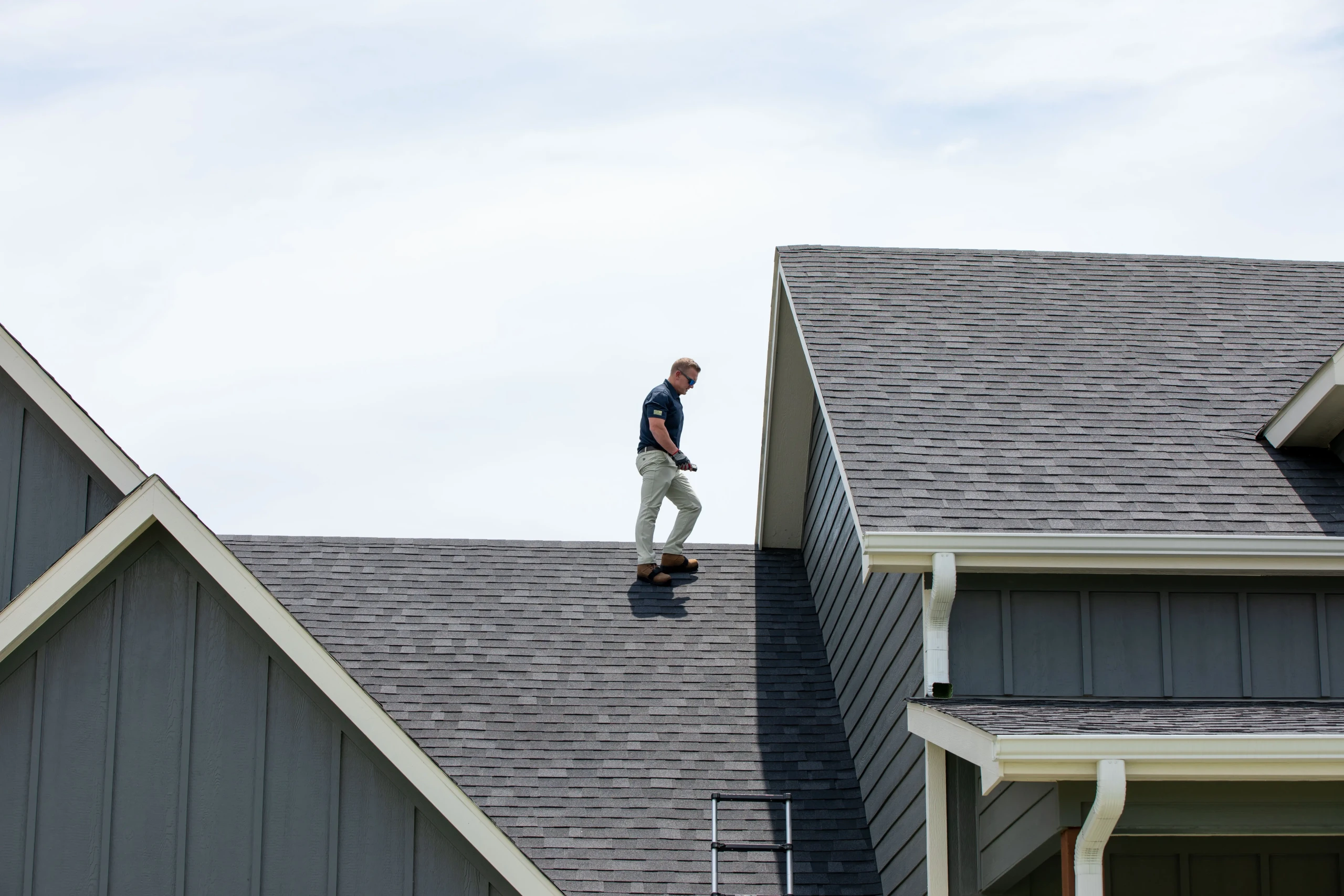 FH_Techs-21 Technician inspecting roof vents on a residential roof