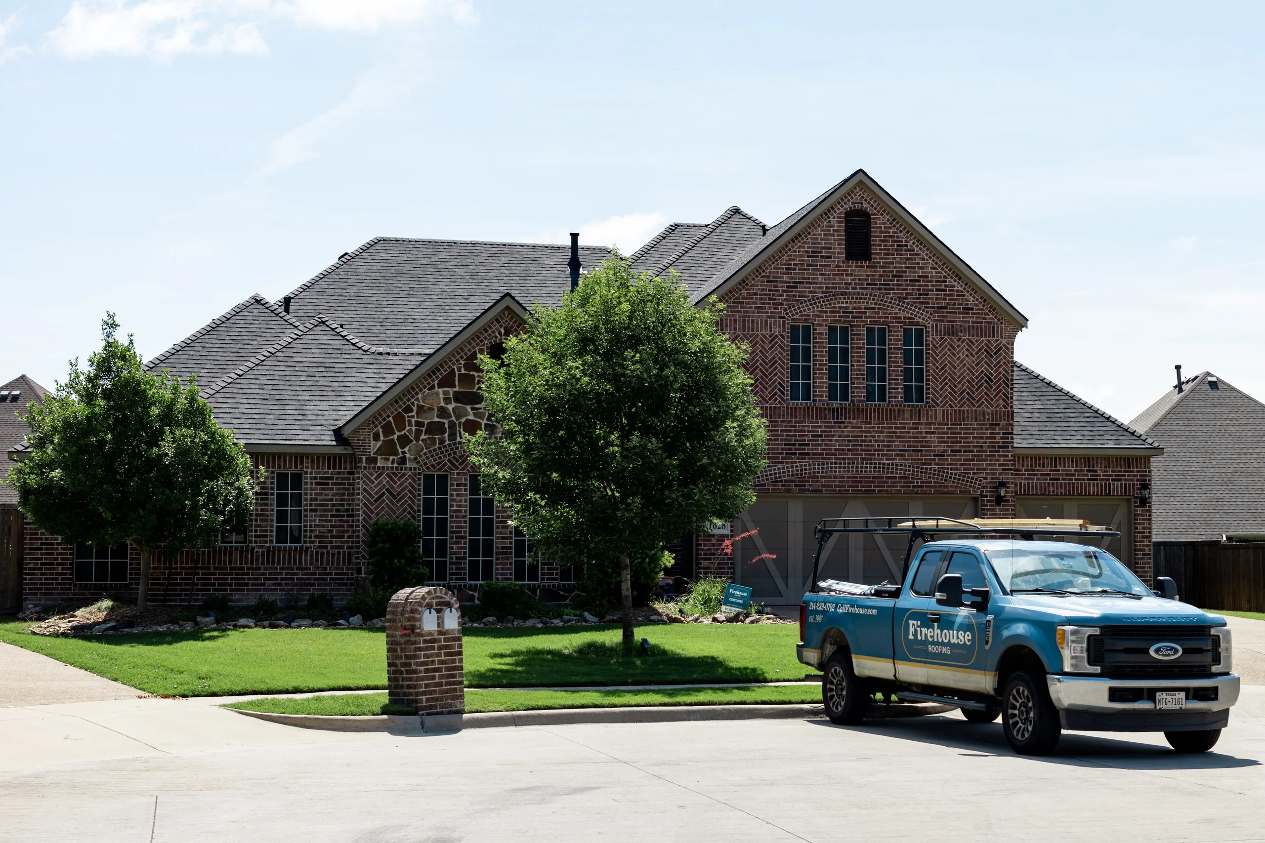 Firehouse Roofing truck outside a completed North Texas roof project