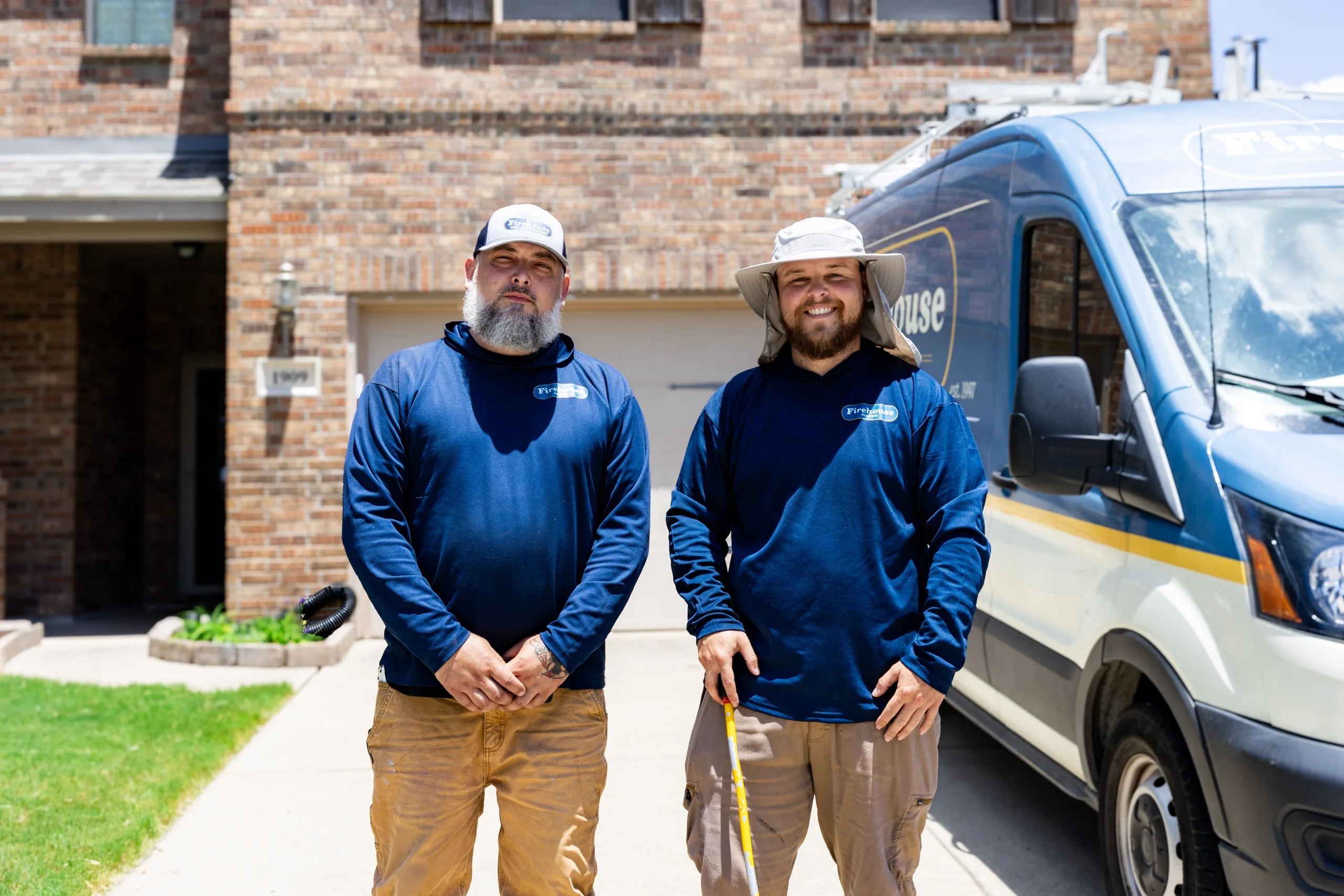 Two members of the Firehouse Roofing field crew