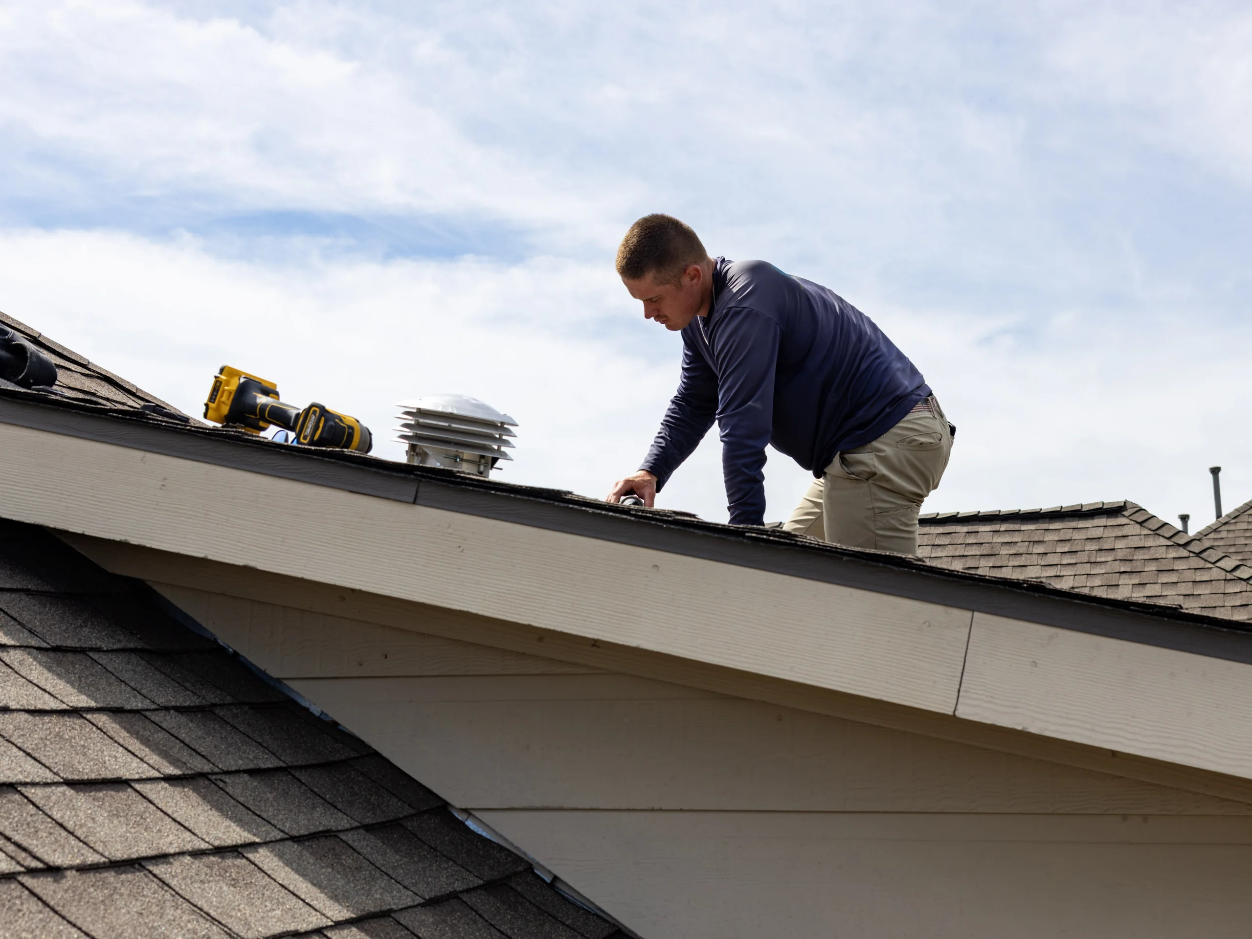 Firehouse Roofing professional inspecting the roof edge
