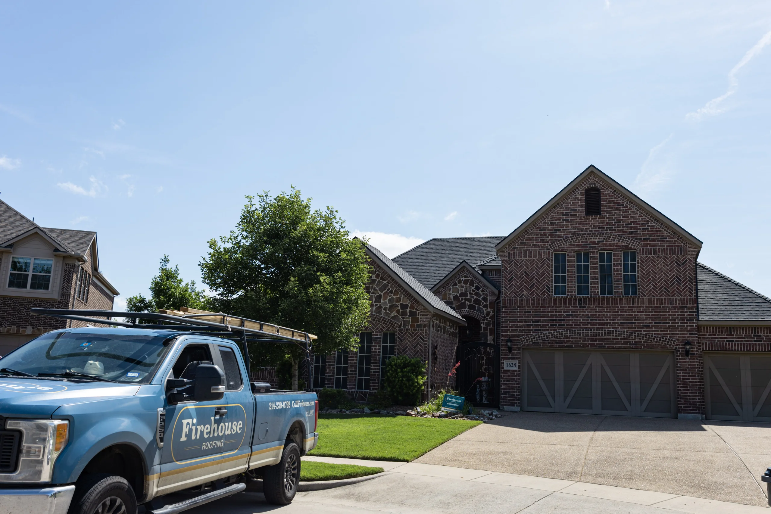 Firehouse Roofing truck in front of a completed residential roof