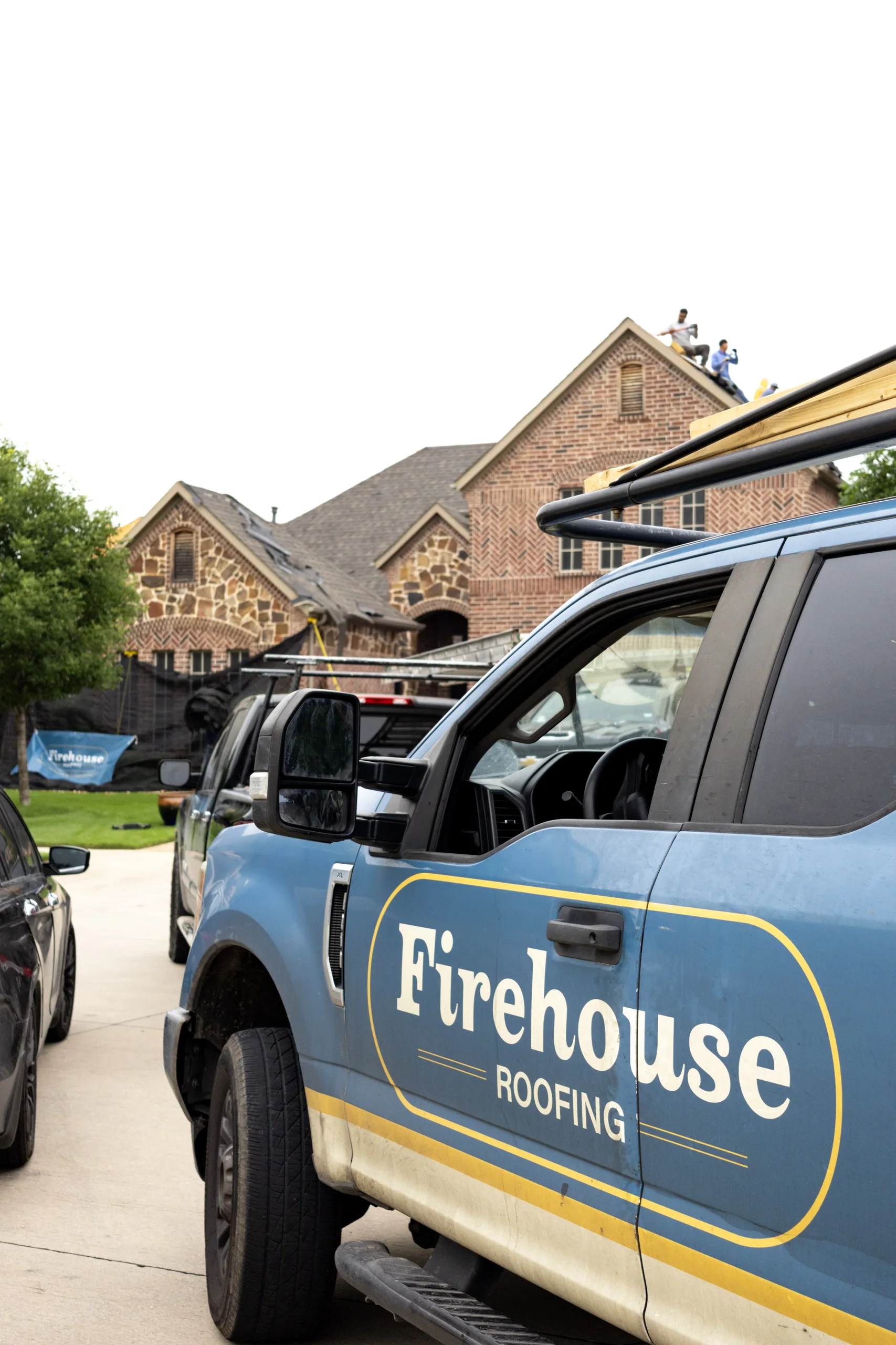 Firehouse Roofing service truck at a residential project
