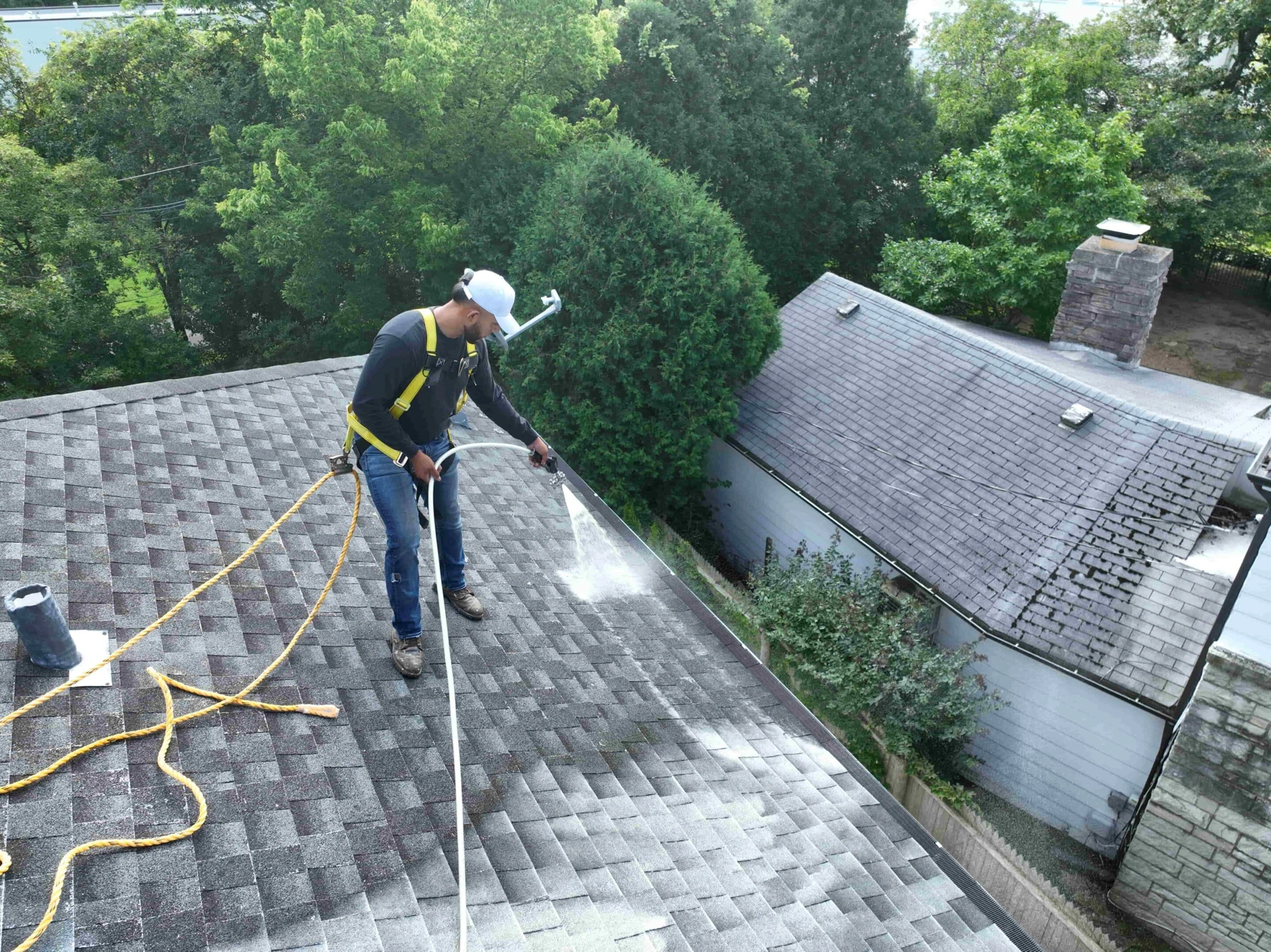 What-sets-Roof-Shield-apart-1-scaled Technician applying a Roof Shield treatment to residential shingles